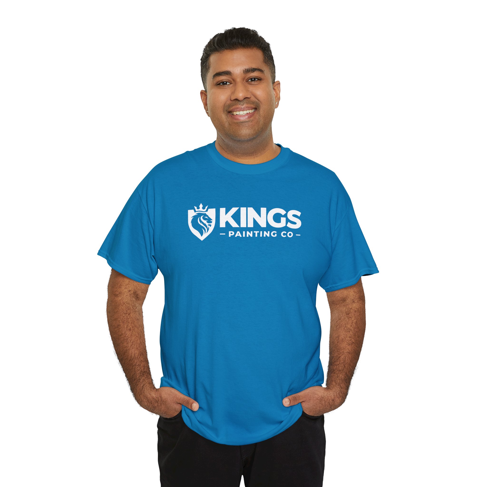 A smiling person wears the Kings Painting Co. Logo T‑Shirt (Classic) | Gildan Ultra Cotton (G5000), featuring a bright blue color and KINGS PAINTING CO with a crown and paintbrush logo on the front, standing against a white background.