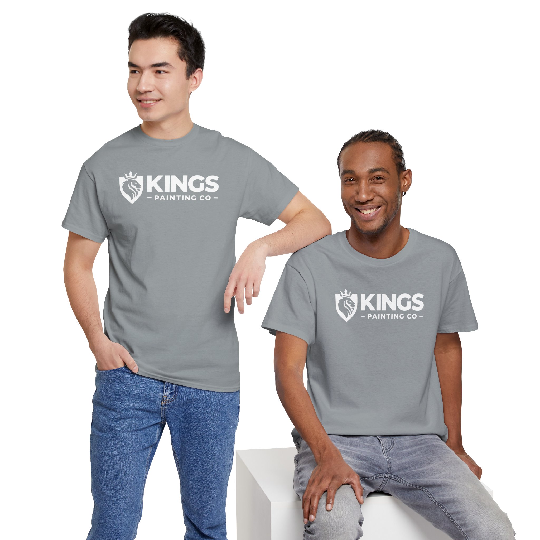 Wearing the Kings Painting Co. Logo T-Shirt (Classic) | Gildan Ultra Cotton (G5000) in gray, one man stands with his hand in his pocket while another sits on a white block, both smiling against a white background.