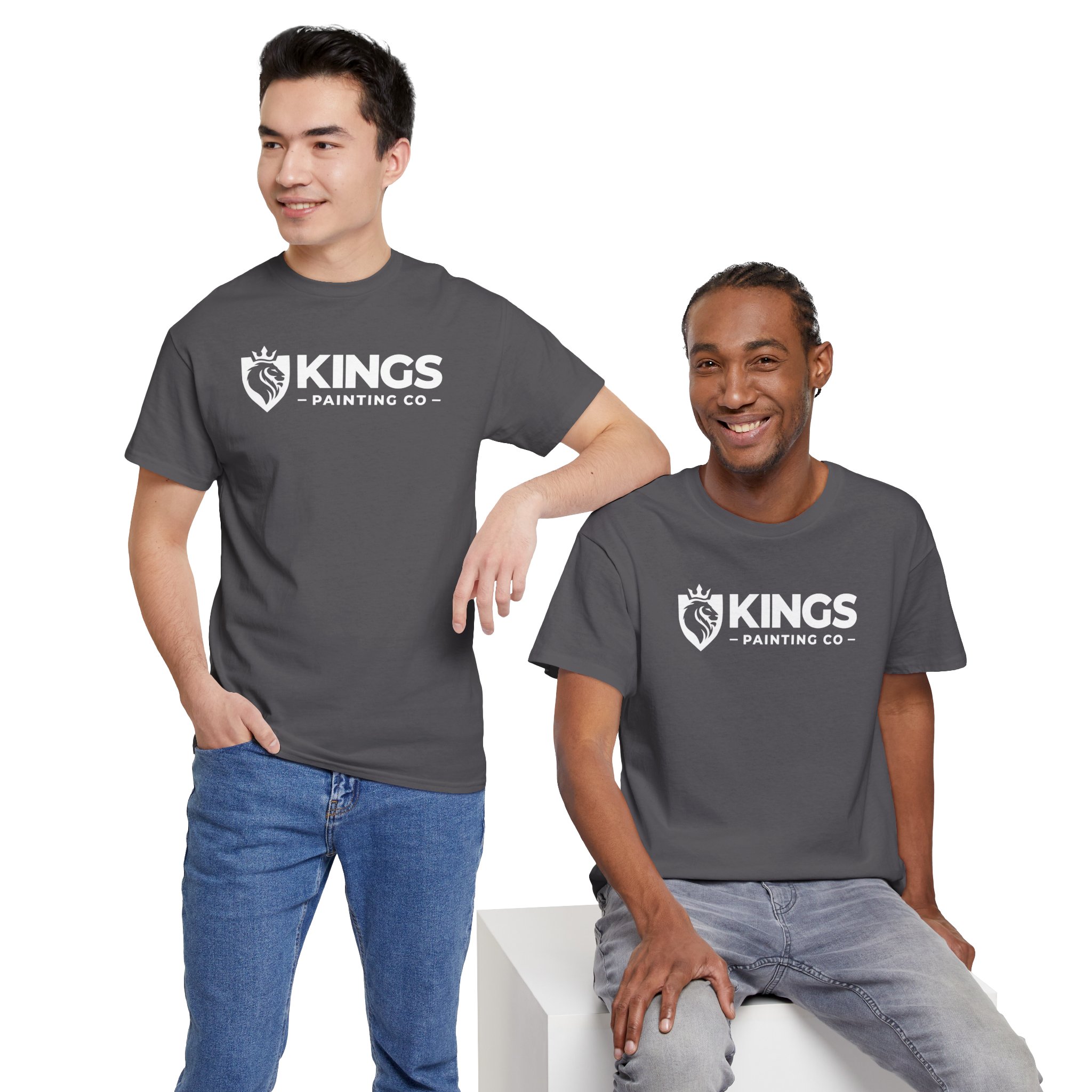 Two men, both smiling against a plain white background, are wearing gray Kings Painting Co. Logo T-Shirts (Classic) made with Gildan Ultra Cotton (G5000); one is standing with his hand in his pocket while the other sits beside him.